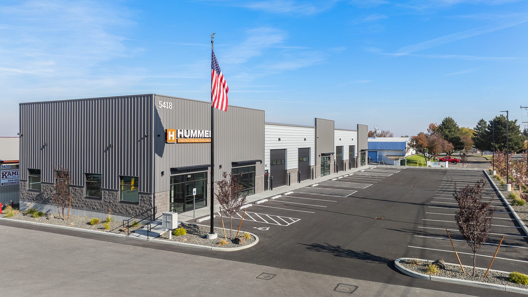 Modern warehouse building with empty parking lot.