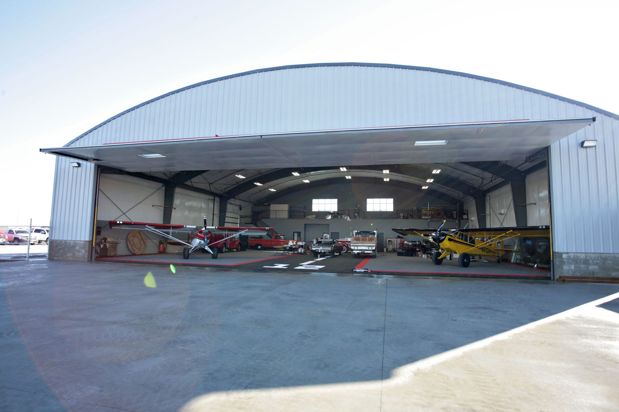 Airplanes parked inside a large hangar.
