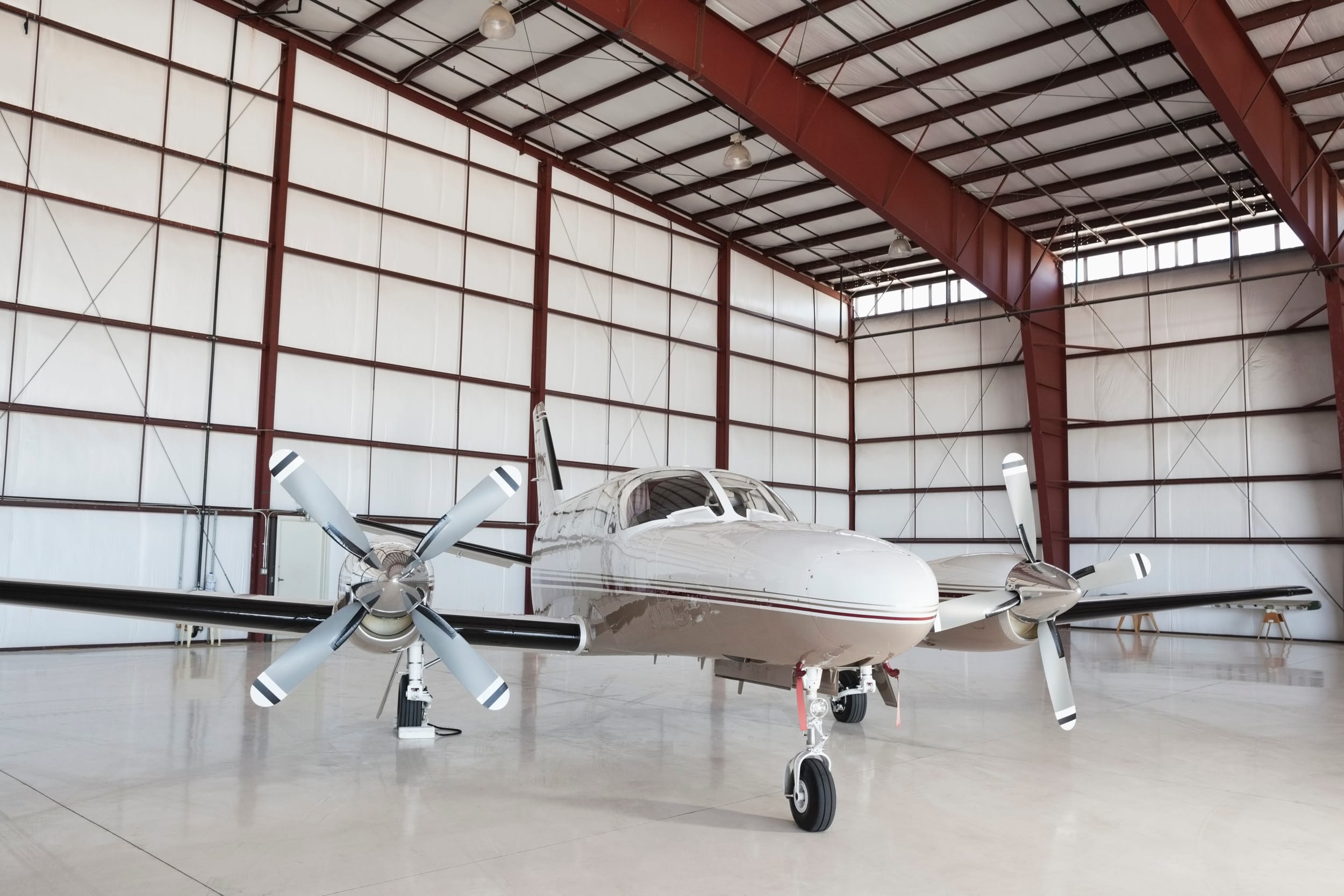 Private airplane parked in large hangar