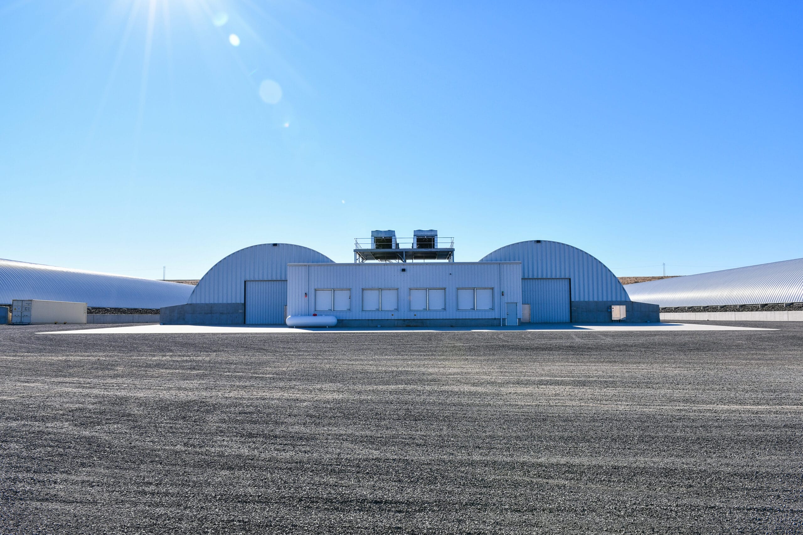 Industrial warehouse under clear blue sky