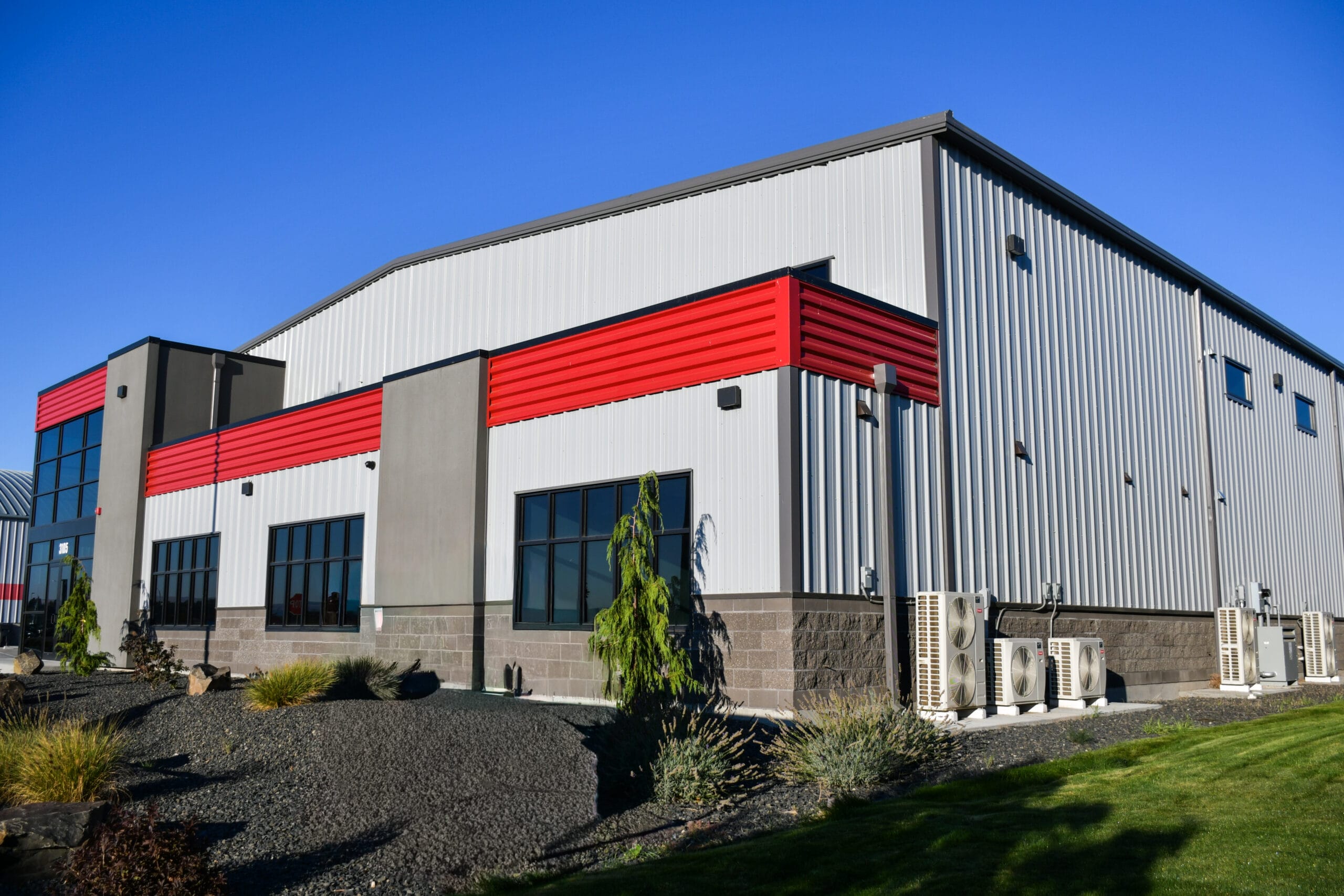 Modern industrial building with red accents and HVAC