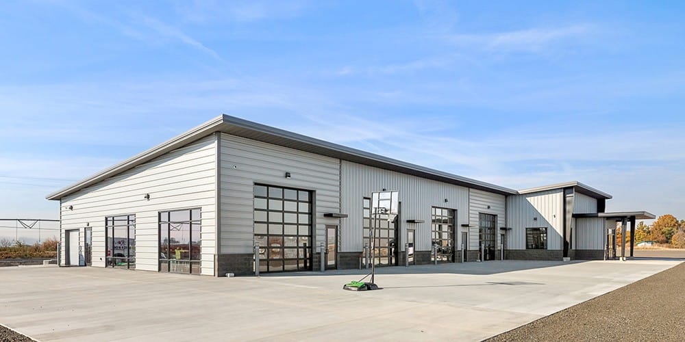 Modern industrial building with large garage doors.